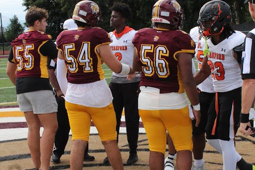  The South Windsor and Stamford captains meet for the coin toss before their game as part of the Connecticut Football Alliance.