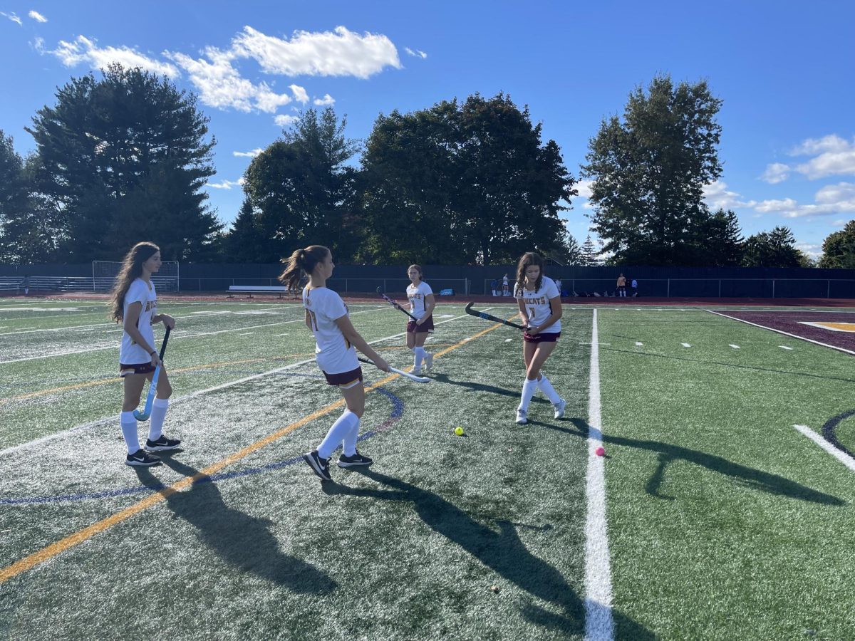 Members of the varsity field hockey team warm up before their Morgan's message game. (Mrs. Quinn)