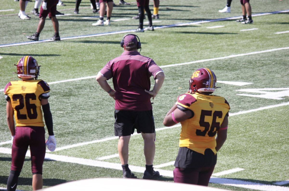 Coach Hodge yelling out audibles for the South Windsor Bobcats.