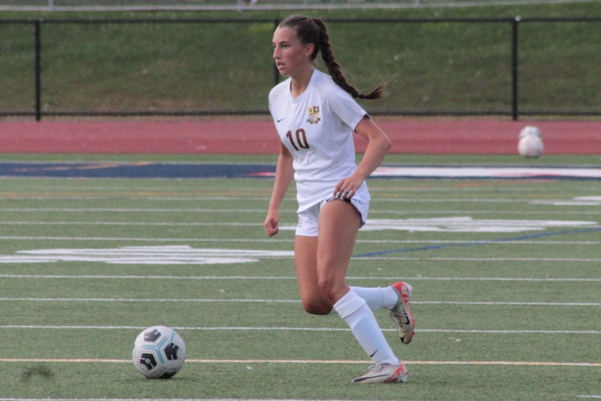 Junior center attacking mid Sam Roux moving the ball up the field. 