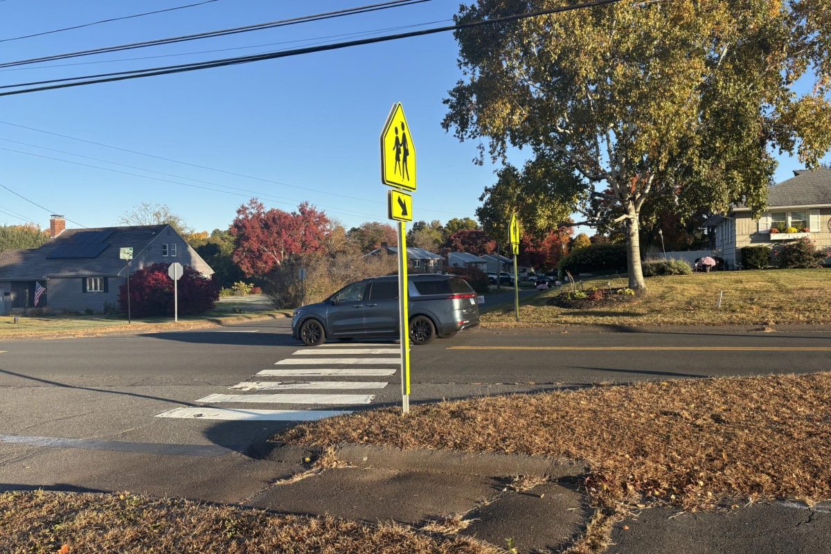 A car driving through crosswalk on Ayers Road in front of South Windsor High School. 