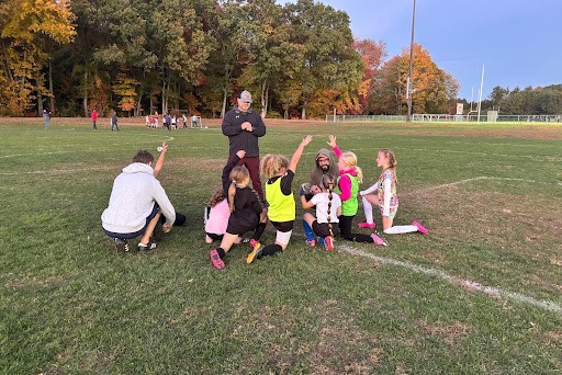 U9 girls coaches talk to them about their most recent game.