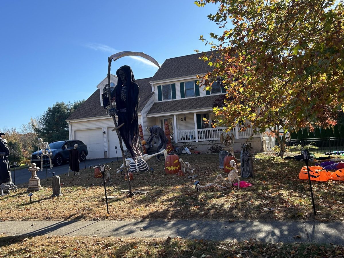 The Grim Reaper stands nearly 20 feet tall towering over a spooky scene below. 