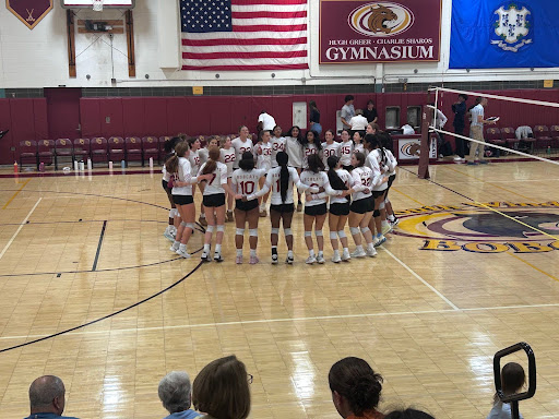 The South Windsor Varsity Volleyball team comes together in a huddle at one of their games. (Kailie Girard)
