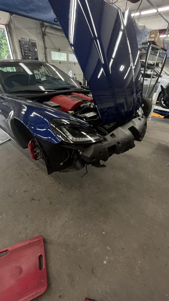 At Vernon Collision, a corvette's bumper is removed to fix a rock chip. 