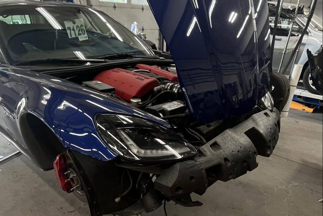 At Vernon Collision, a corvette's bumper is removed to fix a rock chip. 