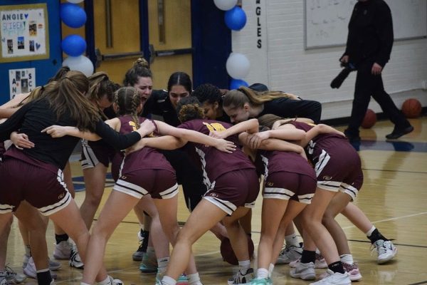 The girls basketball team got hyped in their huddle last year before a game.