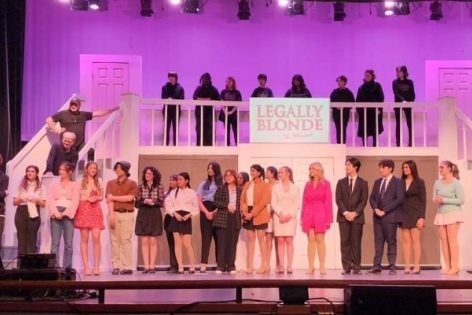 South Windsor High Schools Legally Blonde Cast stands on stage together, after their performance as their director gives a speech. ( Renu Cabot) 