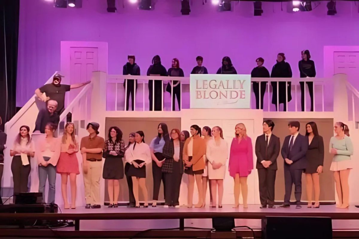 South Windsor High Schools Legally Blonde Cast stands on stage together, after their performance as their director gives a speech. ( Renu Cabot) 