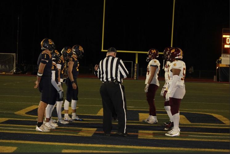 The Bobcats face off against the Simsbury Trojans before the start of the game. 