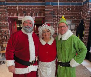 Hodge Claus, Carlson the Elf, & Mrs Barrett celebrate after raising 162$ for cancer research.