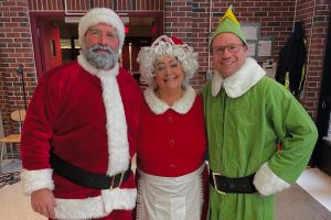 Hodge Claus, Carlson the Elf, & Mrs Barrett celebrate after raising 162$ for cancer research.