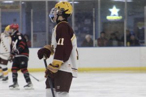 Senior Noah Butler skates to the circle after the whistle for the face off. 