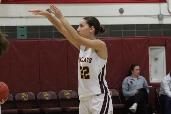 Senior Captain Lauren Graham shooting the ball into the hoop.  