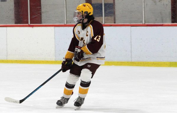 Senior captain Mason Trombley falls back on defense during the Bobcats game versus Simsbury.
