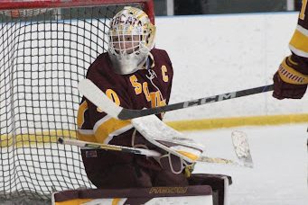 Senior captain Noah Sampson prepares to save a shot during the game against Hamden.