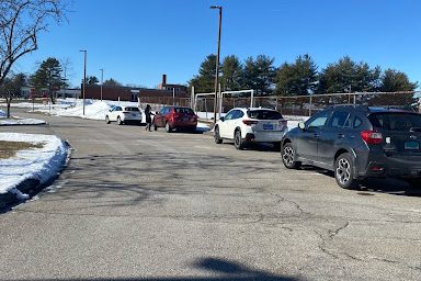 South Windsor High Schools student parking lot, where students are parking on the side of the road in the parking lot because the parking lot is full.