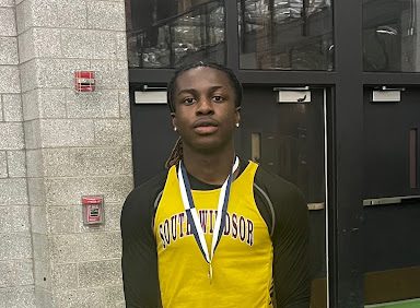 Baidoo posing with his medal after placing in long jump during States. (Coach David Hodge)