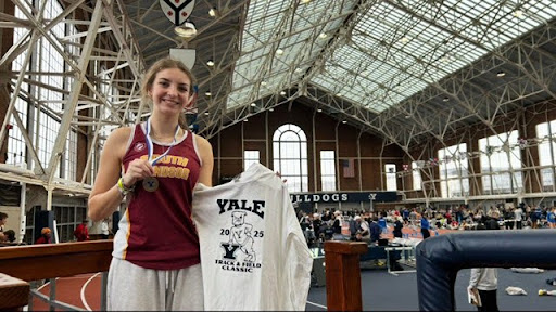  Mead posing with her medal and new Yale Invitational merch. (Mallory Mead)
