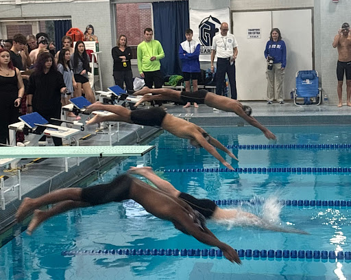 Junior Aditya Patel and Sophomore Tim Obeid dive for the 50 yard freestyle.