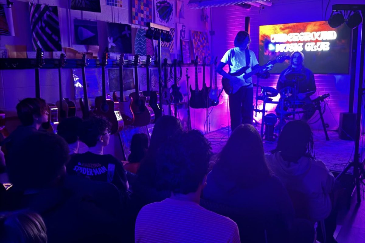 Donald Thibodeau is playing the guitar on stage in Underground Music Club. (Blaze Hartley) 