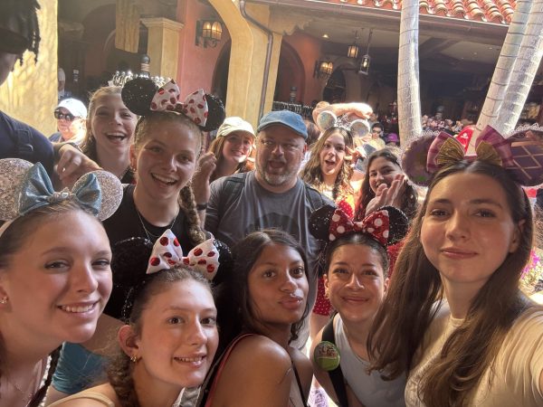 Mr. Martineau poses with students on the music department's Disney trip. (Lauren Graham)