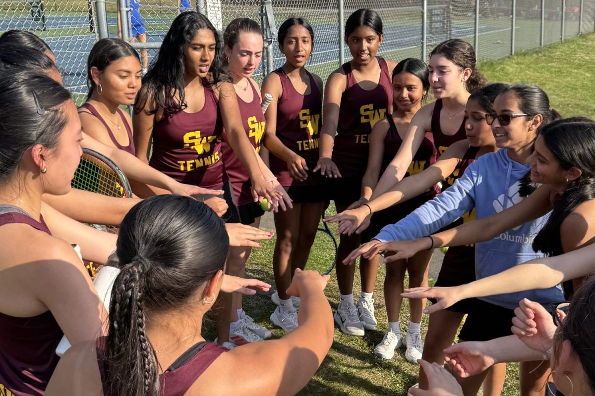 The South Windsor girls tennis team gets together for a team huddle before a home game.  (Mrs. Belval)