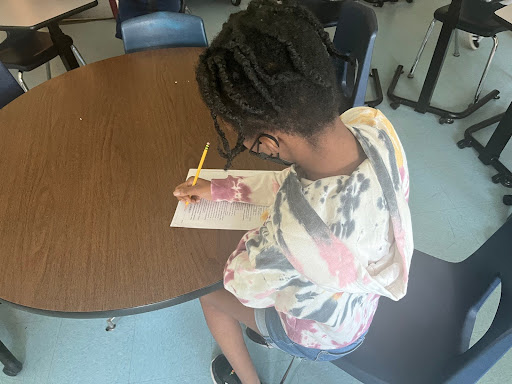 A South Windsor High School student takes a test in a classroom.