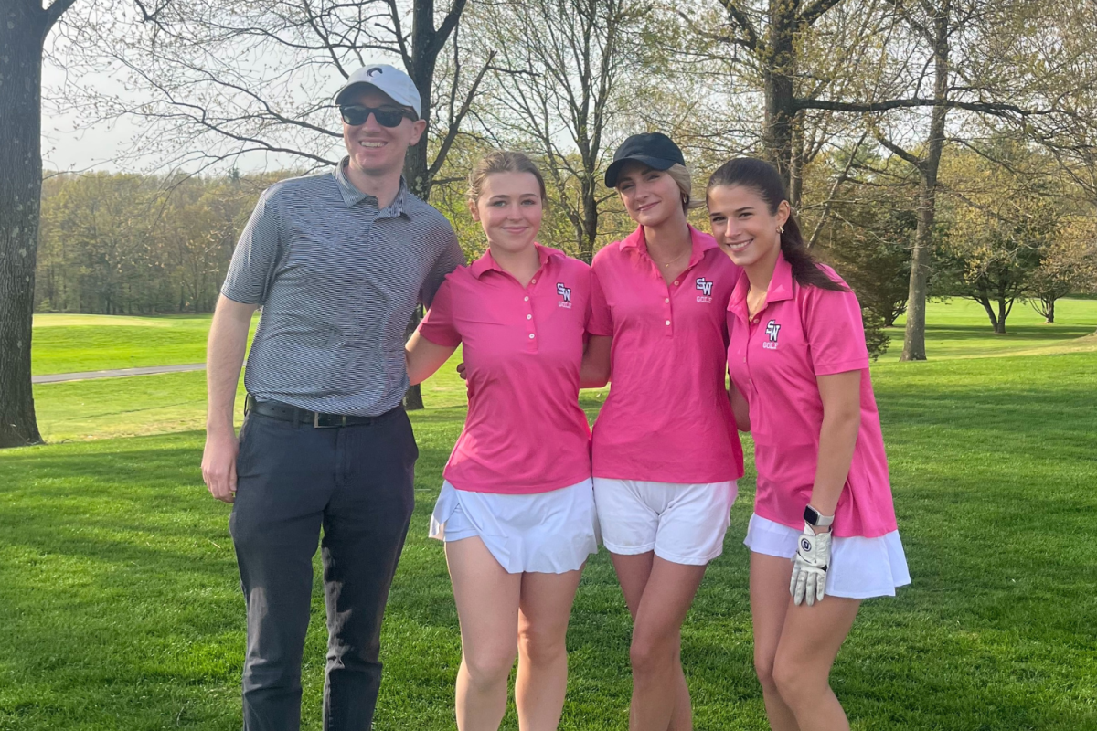 Coach Garrish poses on the course with Maddie Testa, Makayla McGrath, and Ava DeNicolo. (Mrs. Testa)