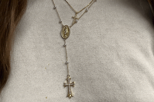 Student poses for a photo representing their Faith by wearing a Cross