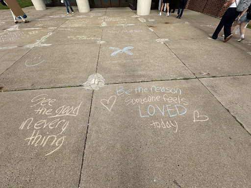 SADD club members spread positivity through chalk art in front of the high school to support Morgan's message.  (Olivia Stoner)