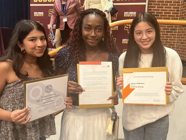 Juniors Ananya Rajan, Elizabeth Sinclair and Audrey Zhang pose for a photo after receiving their book award. (Karmela Malone)