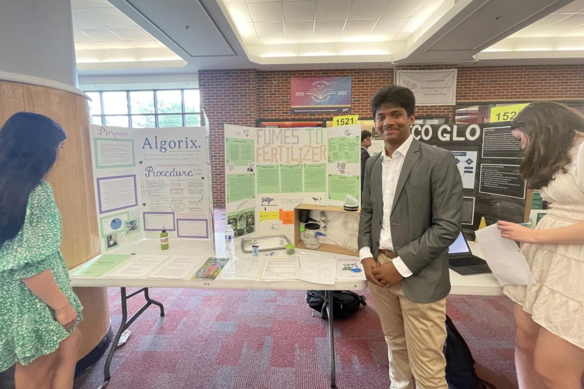 Freshman Aniron Pal stands in front of his science fair project 'Fumes to Fertilizer' converting methane gas to sodium carbonate. (Mrs. Quinn)