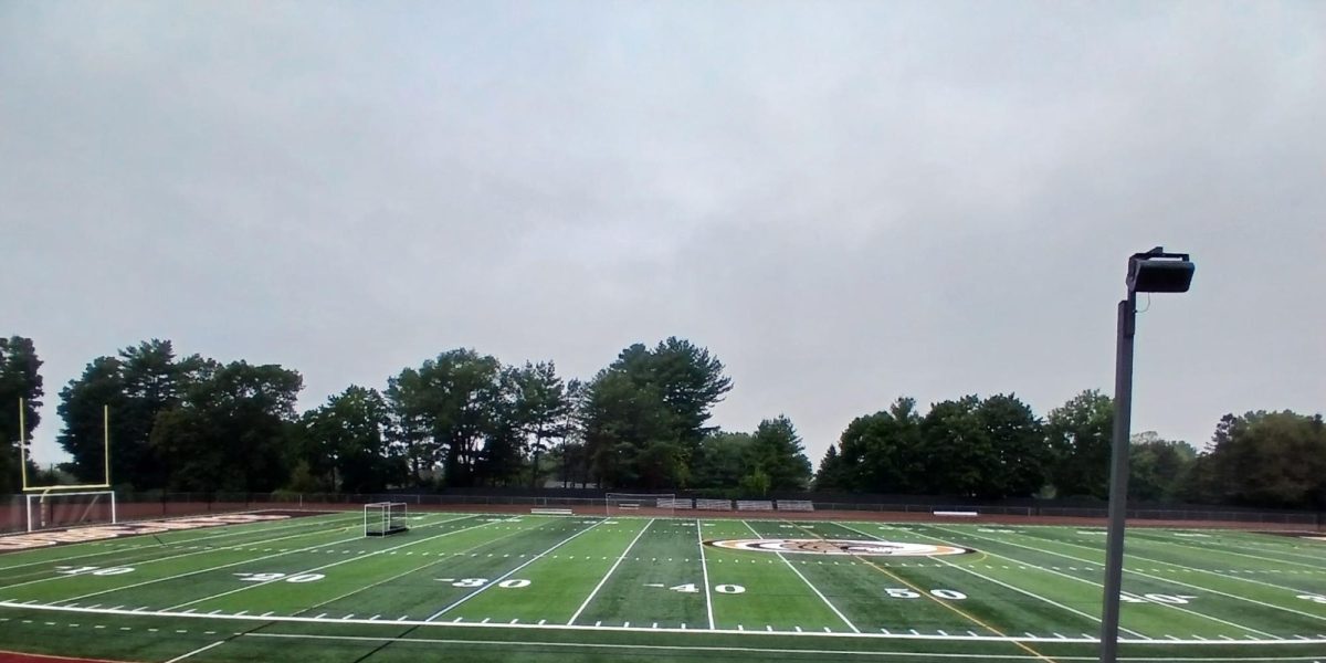 A photo displaying the football turf with no stadium lights.