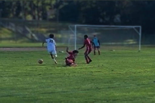 Freshman Adam Elsendyouney took on two defenders and wining the the ball. (Photo courtesy of Mrs. Quiuqui)