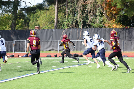 Junior Ryan Faux rushes down the sideline en route to his first of three touchdowns.