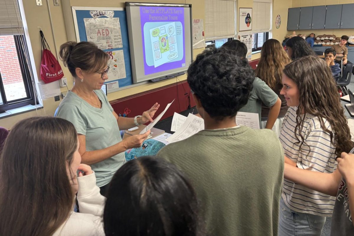 Mrs. Joanne Stavens-Martin checks the work of students in her health class. 