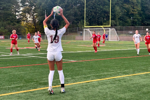 Senior Mia Ruiz throws in the ball from the sideline.