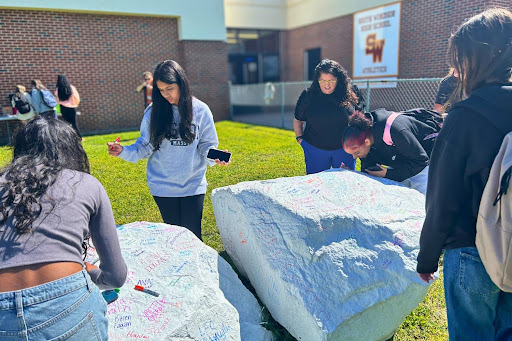 Seniors at SWHS participate in the annual tradition of painting the rock during their lunch periods.