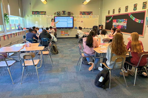 Señora Kesel at the front of the room, giving her usual start-of-the-class agenda.
