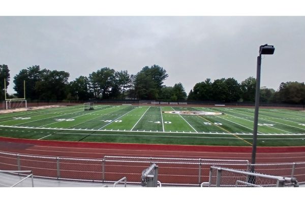A photo displaying the football turf with no stadium lights.