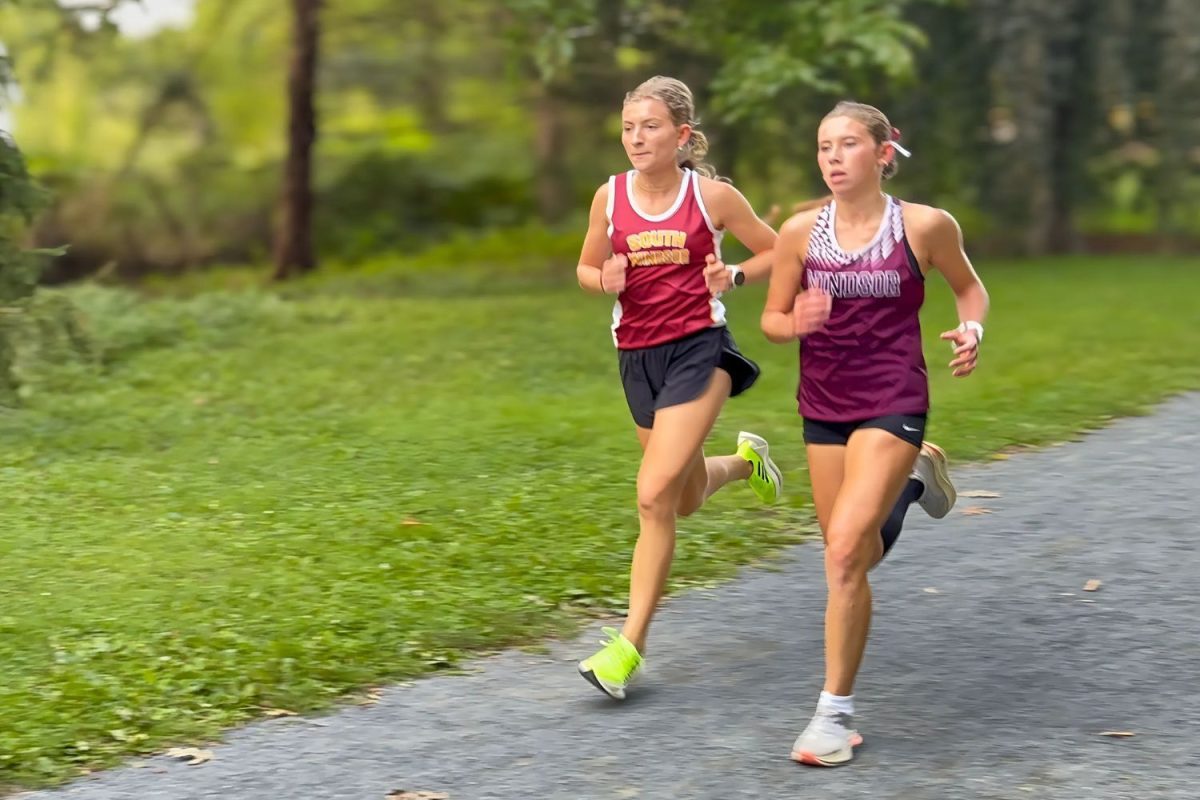 Senior Sofia Holovatska passes one of Windsor's top runners during the home meet. 