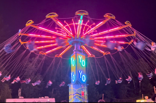 Fairgoers ride the neon swings at the 2025 Wapping Fair 