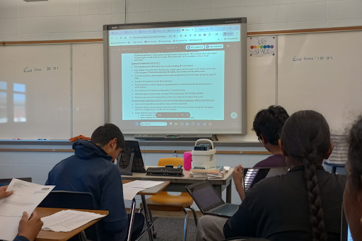 Students are looking at the math topics, CAML rules, and some practice problems on their paper that are helpful to know for the competition. 