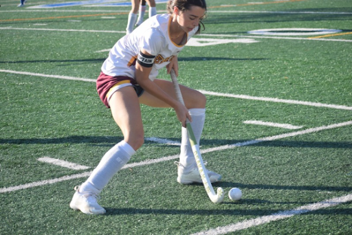 Senior Captain Elsa Gately retrieves the ball in the midfield (Photo Taken by Anika Mandela).