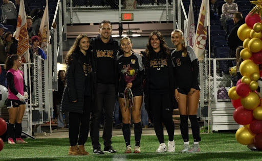 Gabriealla Disalvatore and her family after receiving a rose and getting announced during the 2025 senior night walk out.