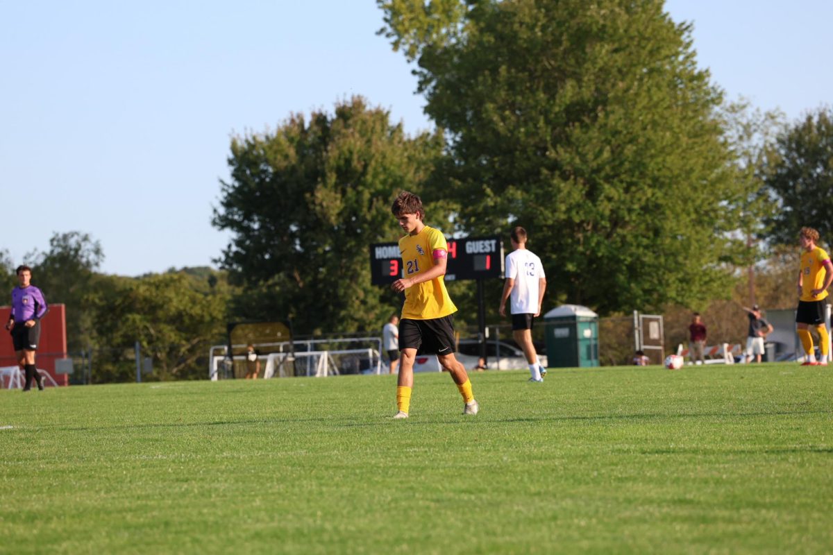 Senior Hayden Xhokaxhiu walks back after scoring his second goal of the game against Lewis Mills.
