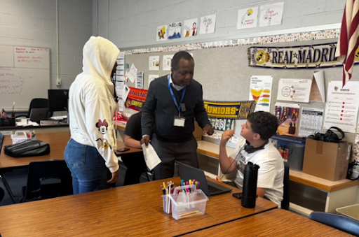 Mr. Nobou converses with his students about the requirements for the assignment.