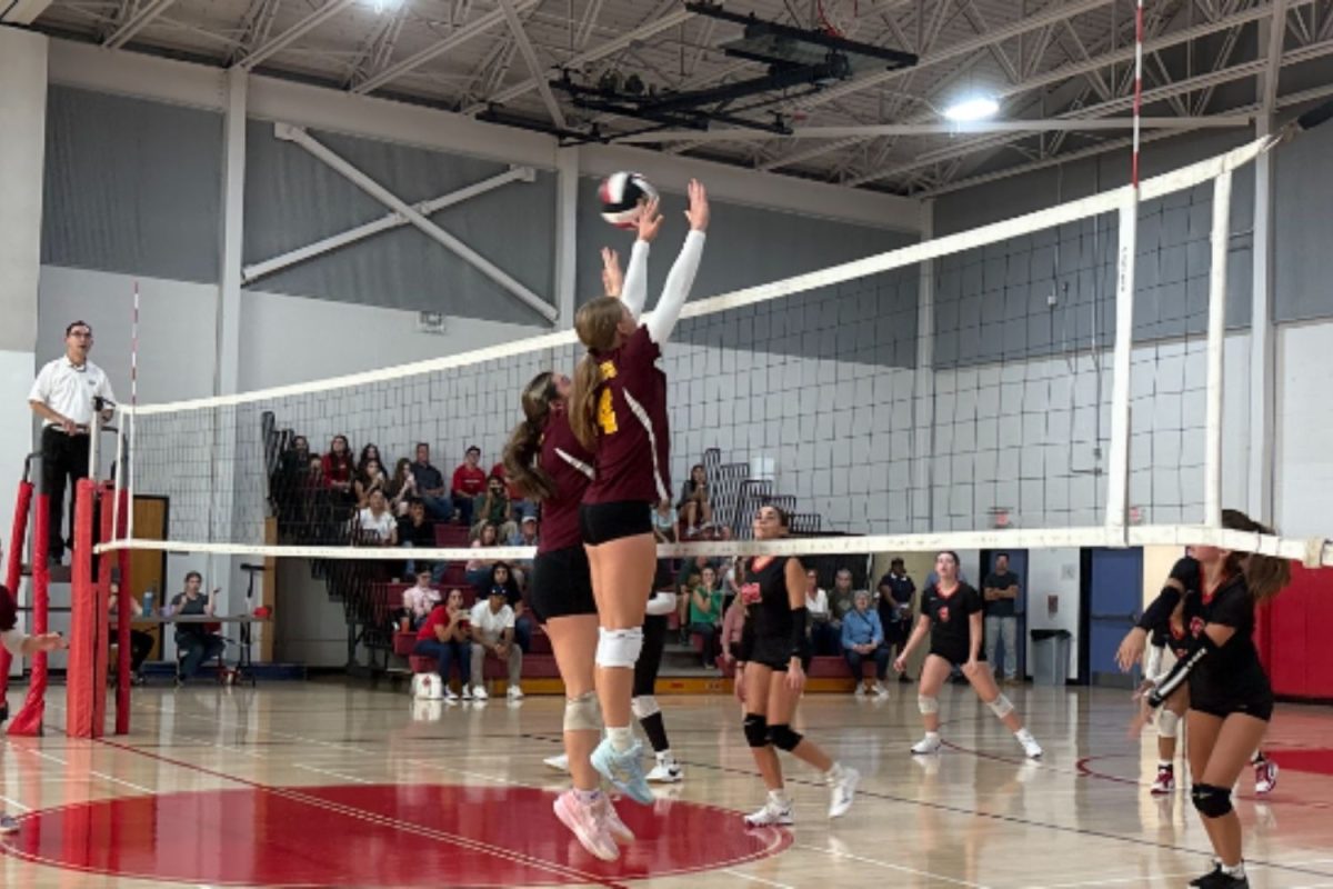 Kincso Kohutics and Vanessa Healey blocking the ball from E.O Smith.