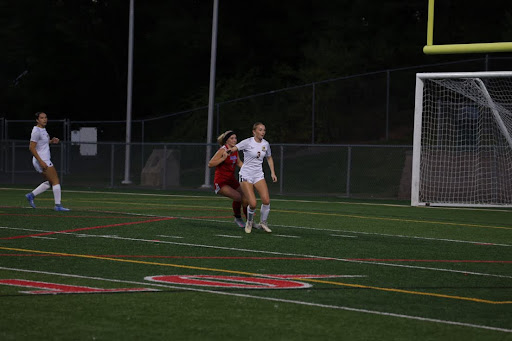 Erin Martin blocking off a pass to a Berlin forward during a win against the Berlin Girls Varsity Soccer Team.
